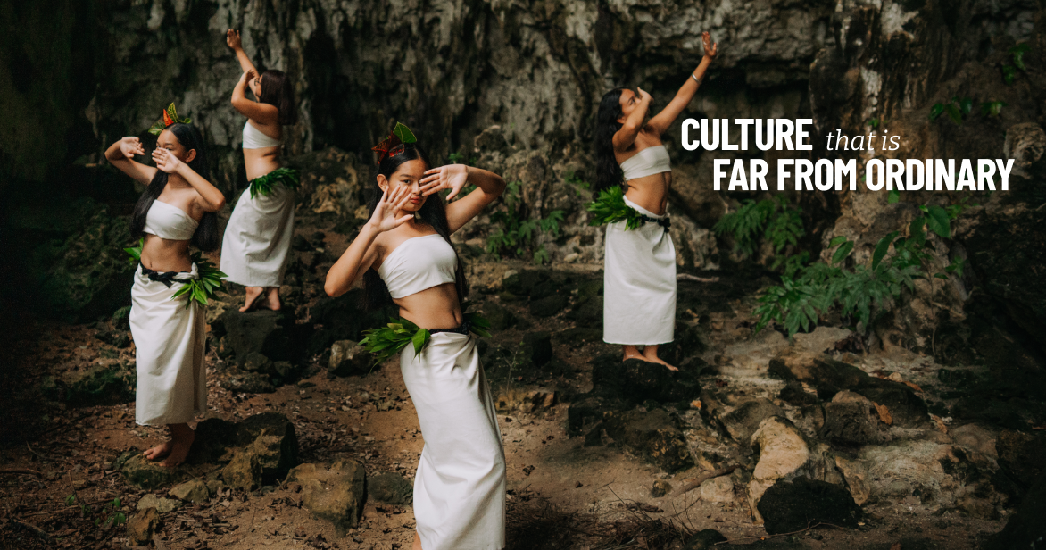 Local women in traditional white attire perform a dance inside the rocky interior of Tonga Cave on Rota.